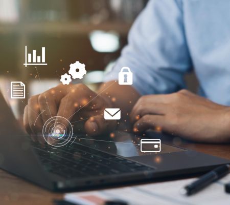 Digital icons representing different systems overlaid on an image of a person clicking on a laptop