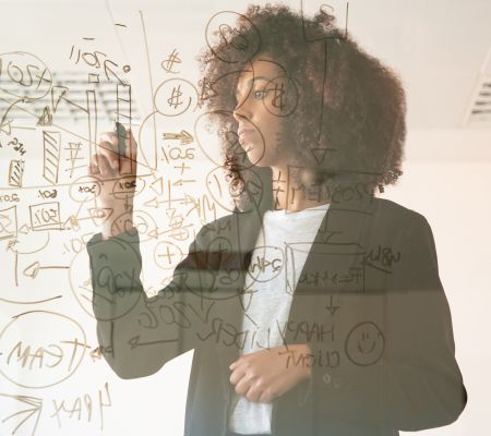 Woman brainstorming her strategy on a glass window