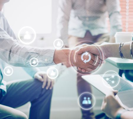 Two people shaking hands with digital icons overlaid