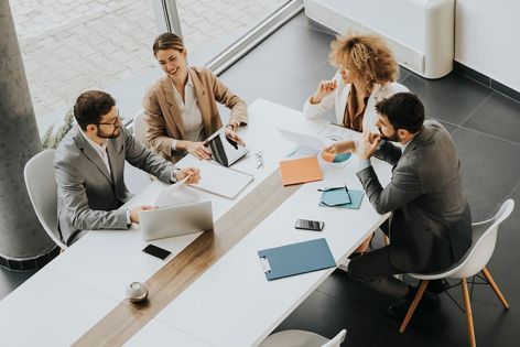 Business people sitting around a table talking