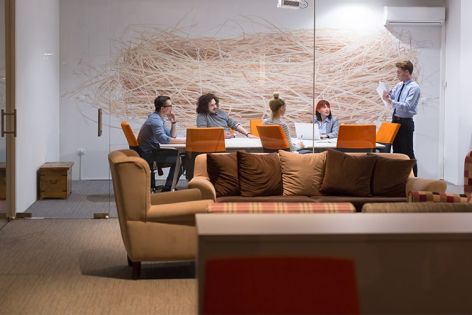 Business people sitting around a table talking