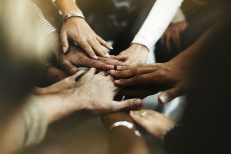 Diverse hands stacked on top of each other